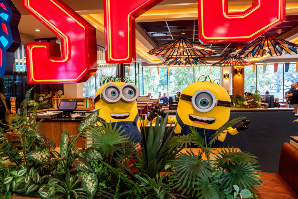 A picture of Minions surrounded by trees and a SPUR LOGO