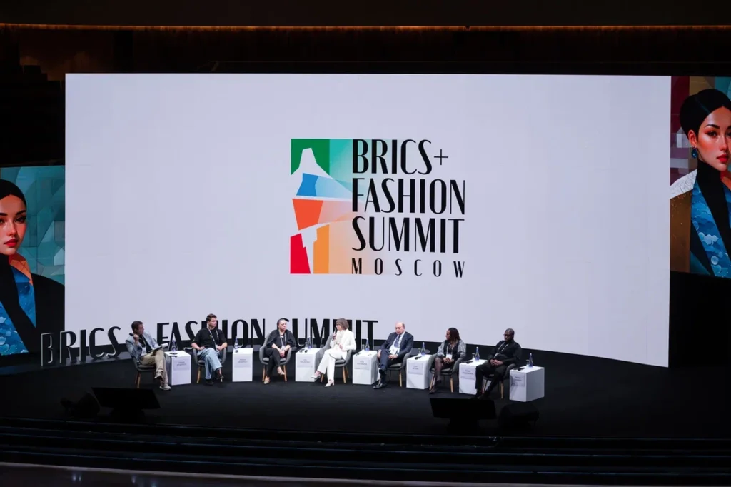 people sitting on the stage at a conference