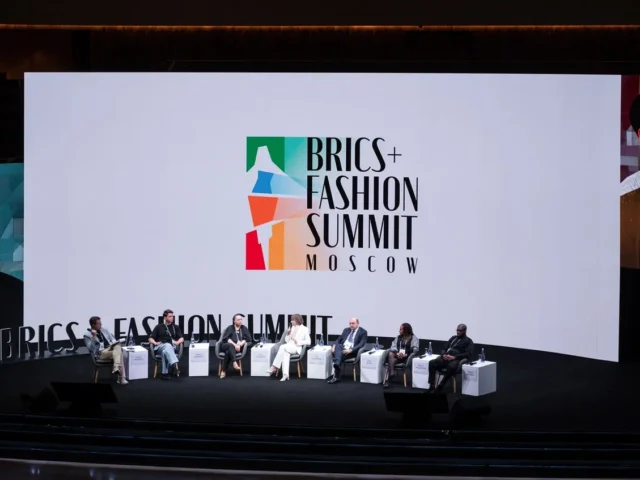 people sitting on the stage at a conference
