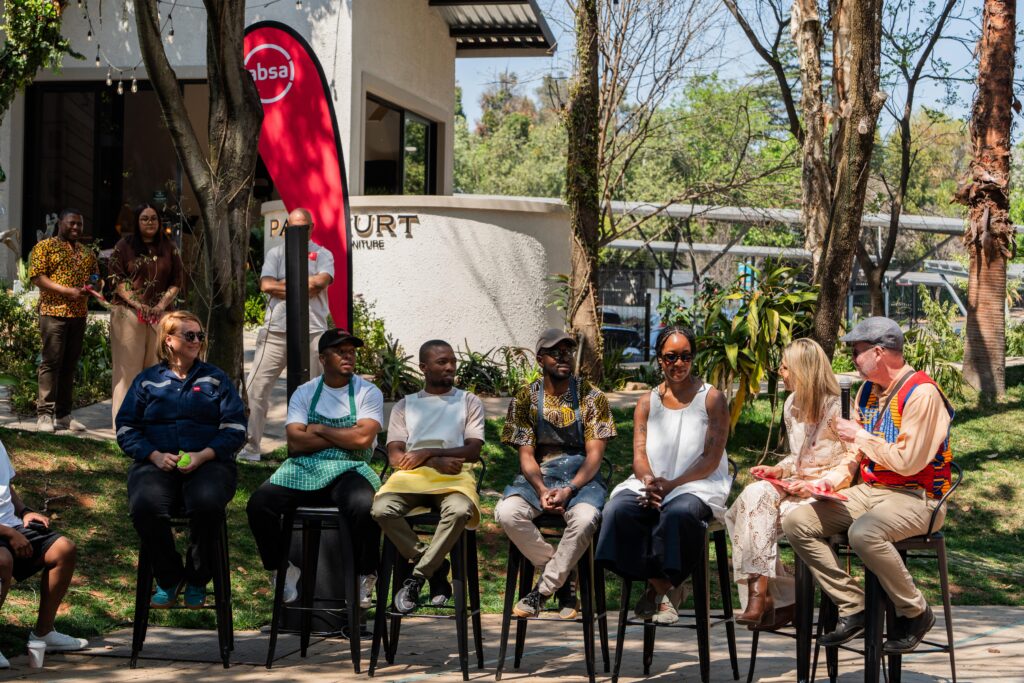A group of people sitting on high stools together