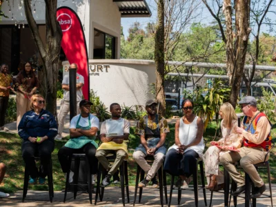 A group of people sitting on high stools together