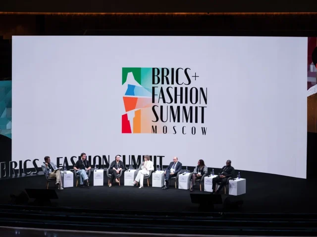 people sitting on the stage at a conference