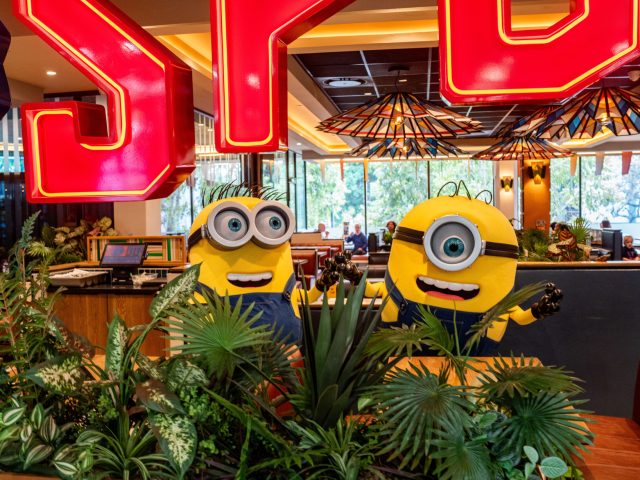 A picture of Minions surrounded by trees and a SPUR LOGO